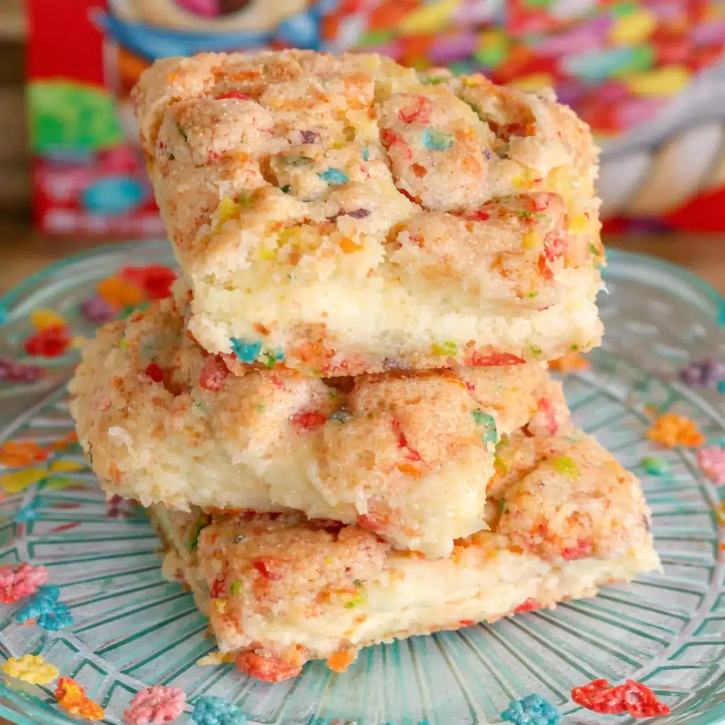 Fruity Pebbles Cookie Cheesecake Bars with colorful cereal and creamy cheesecake layer.