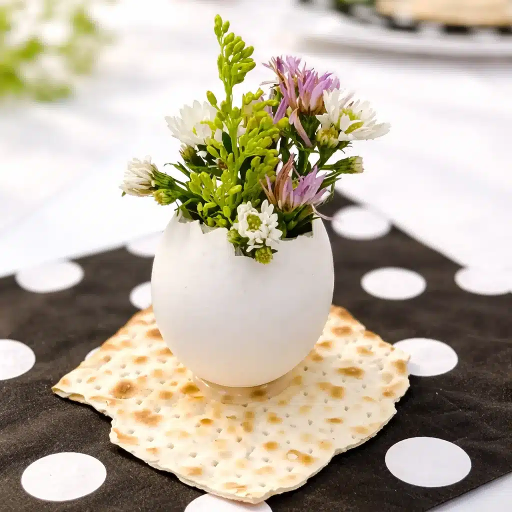 DIY eggshell bud vase displaying tiny spring flowers.