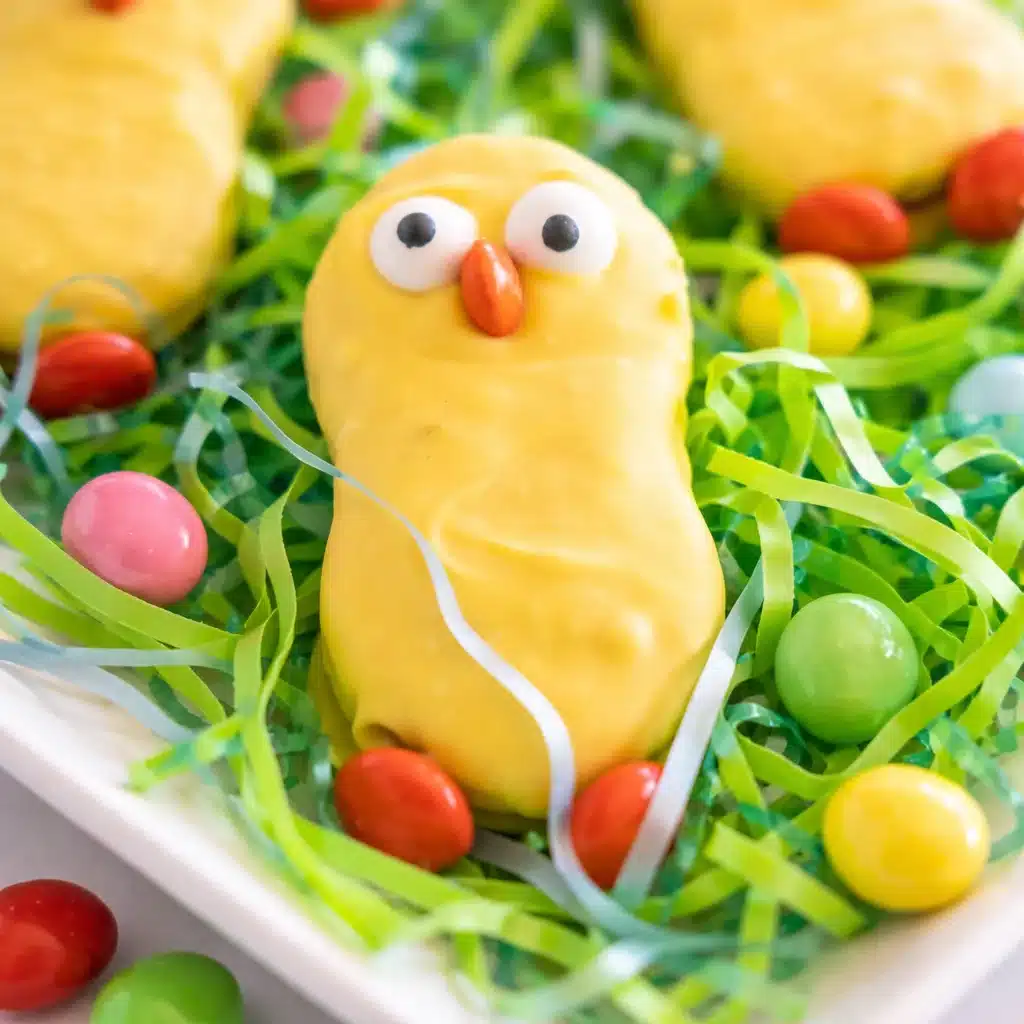 Adorable Nutter Butter Chicks decorated for Easter with candy melts and chocolate chips