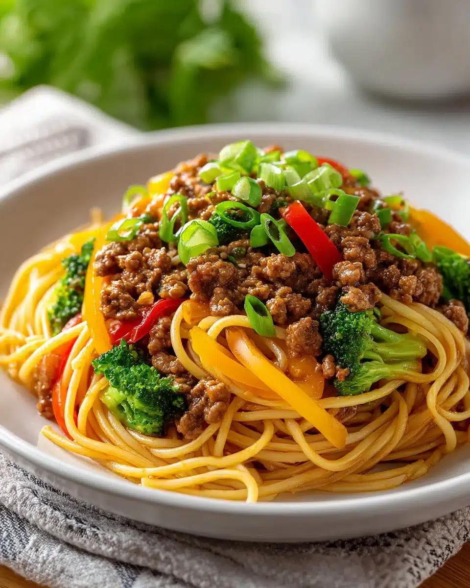 Asian-style ground beef spaghetti dish served with vegetables