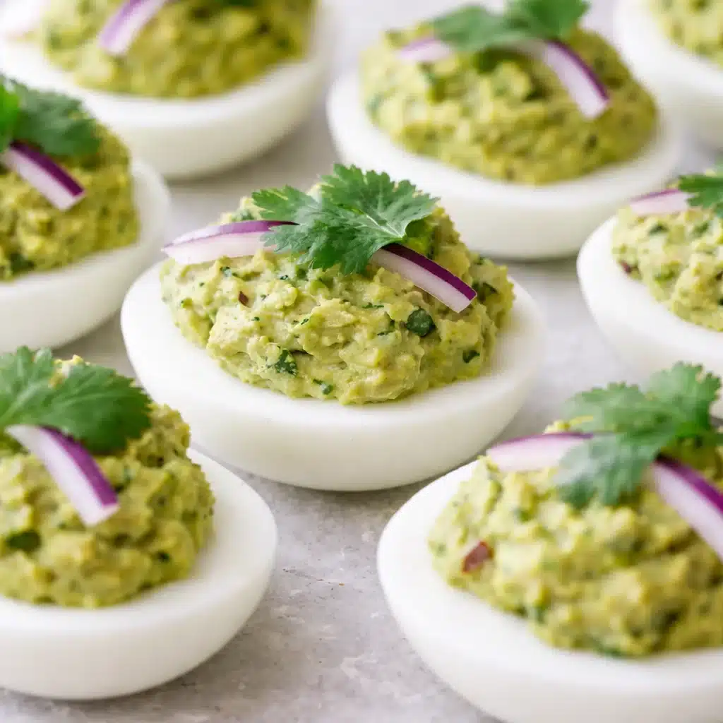 Creamy avocado deviled eggs on a plate, garnished with spices and fresh herbs.