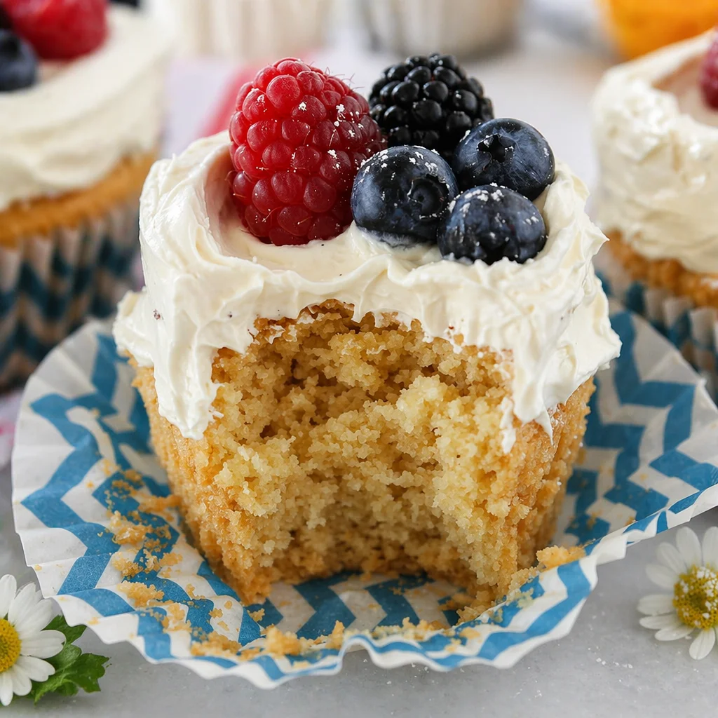 Delicious Fourth of July Vanilla Cupcakes with Buttercream and fresh berries.