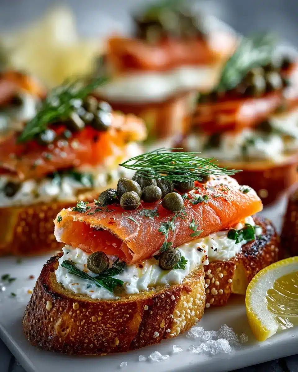 Smoked Salmon Herb Crostini topped with fresh herbs on a wooden platter.