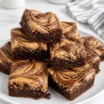 Swirled peanut butter cream cheese brownie dessert topped with chocolate drizzle