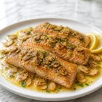 Plate of Brown Butter Trout Almondine with Lemon garnished with almonds