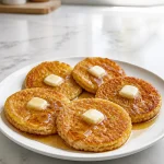 Crispy Rhode Island Johnnycakes served with melted butter on a plate